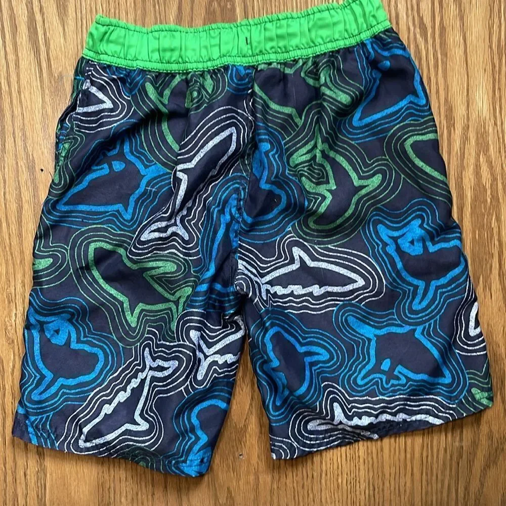 Cherokee swimming shorts. Drawstring waist. Size medium (10/12). Pockets.